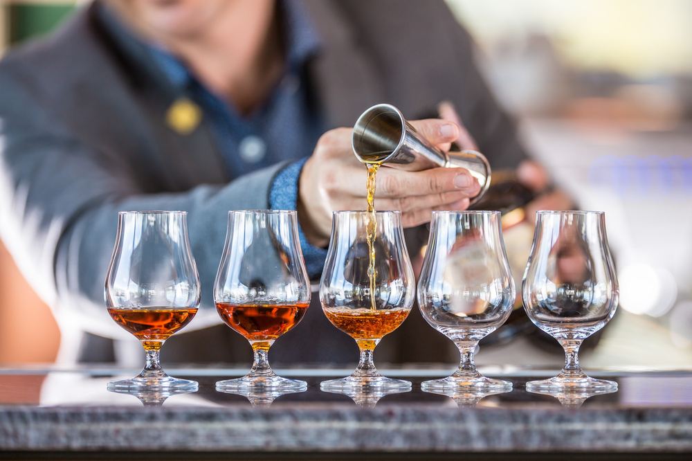 Pouring whisky samples into tasting glasses